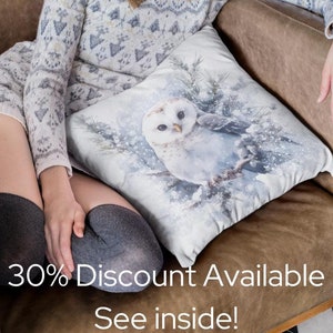 May include: A white throw pillow with a watercolor illustration of an owl in a snowy forest setting. The pillow is on a brown leather couch with a woman sitting on it. The text "30% Discount Available See inside!" is printed on the couch.