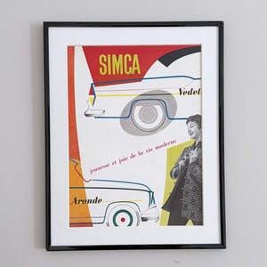 May include: Framed vintage SIMCA Vedette and Aronde car advertisement. The poster features illustrations of the cars with the SIMCA logo in red and yellow. The text "jeunesse et joie de la vie moderne" is also visible. The poster is framed in a black frame.