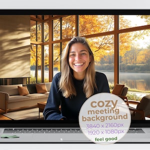 May include: A laptop screen displays a cozy meeting background with a smiling person. The background features a living room with a sofa, chairs, and a large window overlooking a lake and autumn trees. The text on the screen says "cozy meeting background" and "feel good".