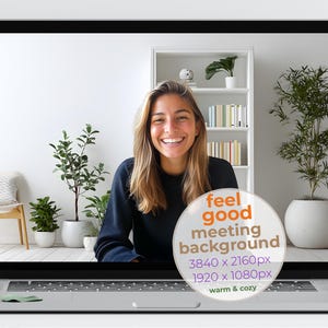 May include: Laptop screen displaying a smiling person in a navy blue top, with a white background and plants. A graphic overlay reads "feel good meeting background" with resolution details and "warm & cozy".