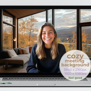 May include: A laptop screen displays a cozy meeting background. The background features a woman smiling in front of a window with a view of a cabin interior and fall foliage. Text on the screen reads "cozy meeting background" and resolution details.