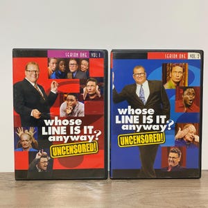 May include: Two DVD cases for Whose Line Is It Anyway? Season One, Volume 1 and Volume 2. The covers feature Drew Carey in a suit and tie, surrounded by smaller photos of cast members. Both cases include the text UNCENSORED! in yellow boxes.