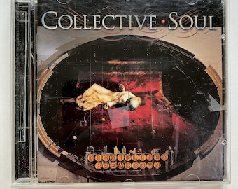 May include: A CD case with a black and white image of a person lying on a red surface. The text "COLLECTIVE SOUL" is in the top right corner and "DISCIPLINED BREAKDOWN" is in the bottom center.