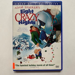 May include: DVD of Adam Sandler's animated film "Eight Crazy Nights." The cover features a cartoon image of Adam Sandler, a snowy town, and other characters. The text reads "The ultimate battle between naughty and nice."