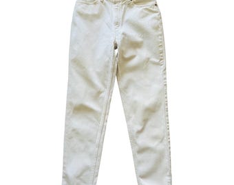 May include: Cream-coloured denim jeans with a classic five-pocket design. The jeans have a button and zip closure, belt loops, and a straight leg fit. The fabric appears to be a medium-weight denim.