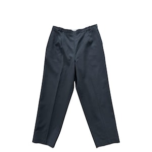May include: Dark gray trousers with a button closure and pleats. The pants have a straight leg design and are made of a solid, opaque fabric. The trousers are displayed on a white background.