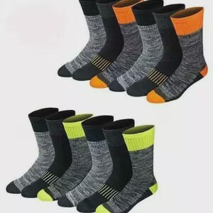 May include: Two sets of crew socks. Each sock has a black cuff, heel, and toe. The socks have a gray marled pattern on the body. One set has orange accents, the other has yellow accents. The socks are made of a thick material.