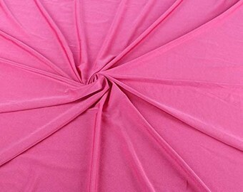 May include: A close-up of a bright pink fabric with a smooth, silky texture. The fabric is draped and folded, creating soft, flowing lines.