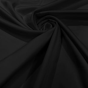 May include: Black fabric with a smooth, silky texture. The fabric is draped and folded, creating soft curves and folds.