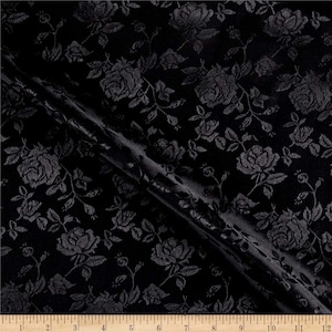 May include: Black fabric with a raised rose pattern. The fabric is smooth and has a subtle sheen.