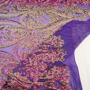 May include: Purple mesh fabric with pink and gold sequins in a paisley pattern.