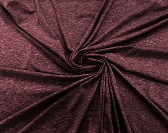 May include: Close-up of a deep burgundy fabric with a textured, slightly rough surface. The fabric is folded and twisted, creating a swirling pattern.