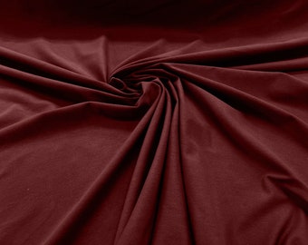 May include: A close-up of a deep burgundy fabric, showing the texture and drape of the material.