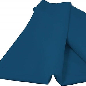 May include: A folded piece of teal blue tissue paper.