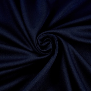 May include: A close-up of a dark blue fabric with a smooth texture. The fabric is folded and draped, creating a soft, flowing look.