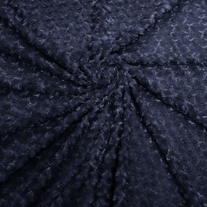 May include: A dark blue fabric with a swirling pattern of raised roses. The fabric is soft and plush, and would be perfect for a variety of craft projects.