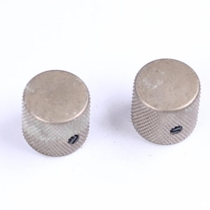 May include: A white ceramic mug with a black handle and the text "But First, Coffee" in a handwritten style. The mug is on a white surface. The mug is approximately 4 inches tall.