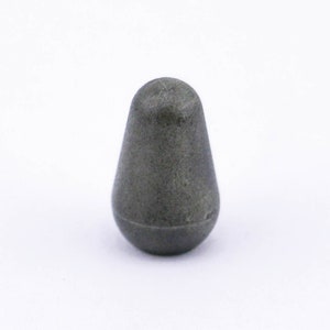 May include: A small, gray, teardrop-shaped knob. The knob is made of a smooth, hard material.