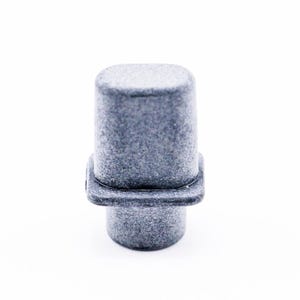 May include: A gray plastic knob with a square base and a rounded top. The knob has a textured surface.