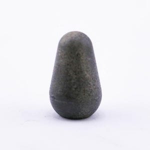 May include: A small, dark gray, pear-shaped object with a smooth, slightly textured surface.