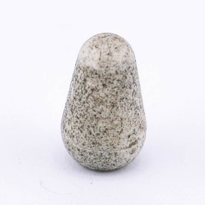 May include: A small, white, speckled ceramic knob with a rounded, teardrop shape.