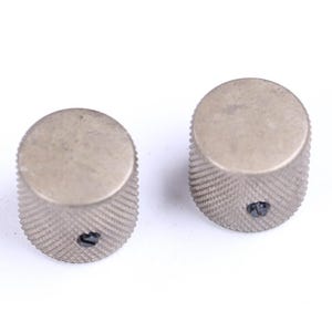 May include: A white ceramic mug with a black handle and the text "But First, Coffee" in a black, handwritten-style font. The mug is on a white surface.