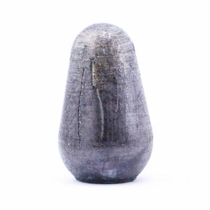 Könnte beinhalten: Ein dunkelgrauer, runder und glatter Flaschenverschluss aus Keramik.