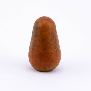 May include: A small, brown, ceramic knob with a rounded top and a textured surface.