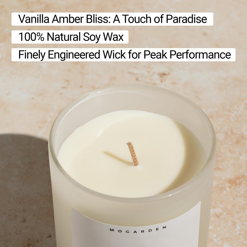 May include: A close-up of a candle in a frosted glass container. The candle is a creamy off-white color with a tan wick. Text on the image reads "Vanilla Amber Bliss: A Touch of Paradise", "100% Natural Soy Wax", and "Finely Engineered Wick for Peak Performance."