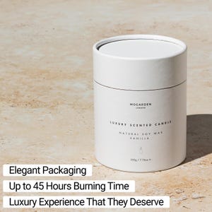 May include: A white cylindrical candle container with a black lid. The label reads "MOGARDEN LONDON LUXURY SCENTED CANDLE NATURAL SOY WAX VANILLA" and "220g / 7.76oz". The text "Elegant Packaging", "Up to 45 Hours Burning Time", and "Luxury Experience That They Deserve" are also visible.
