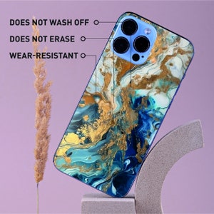 a blue and gold marble phone case sitting on top of a stand