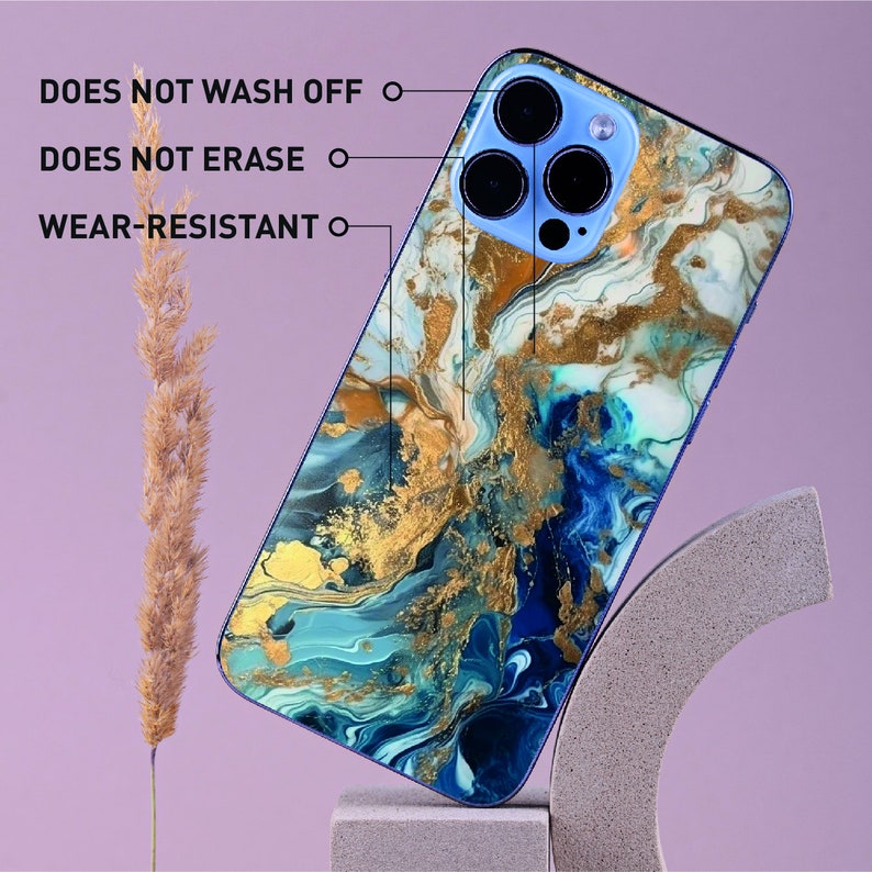 a blue and gold marble phone case sitting on top of a stand