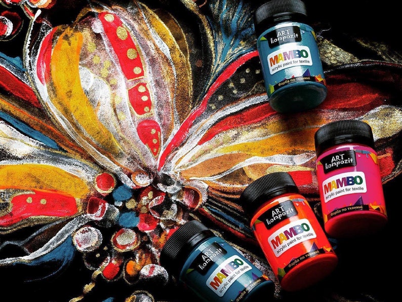 May include: Four bottles of acrylic paint for textile, labeled "MAMBO" in a colorful abstract background. The paint colors are turquoise, pink, orange, and blue.