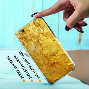 a person holding a cell phone in their hand