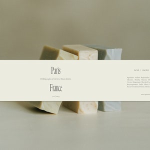 May include: Three bars of soap, one in rose, one in smoke, and one in espresso, with the text "Paris Drinking a glass of wine in Le Marais district France" and "ROSE | SMOKE | ESPRESSO" on a white background.