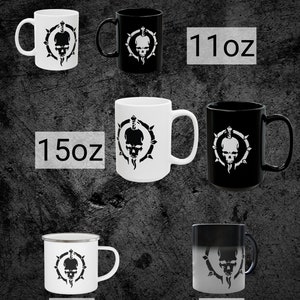May include: White and black ceramic mugs with a skull and sword design. The mugs are available in 11 oz, 15 oz, and 12 oz sizes. There is also a 11 oz color changing mug.