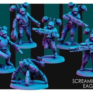 May include: Five miniature figures of soldiers wearing futuristic armor and holding weapons. The figures are painted in shades of blue and gray. The figures are standing on circular bases. The figures are arranged in a semi-circle. The figures are labeled "Screaming Eagles".