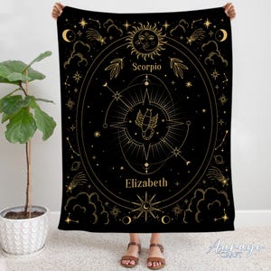 May include: Black tapestry with gold zodiac symbols and the name Elizabeth. The tapestry features a scorpion, stars, and a sun with a face.