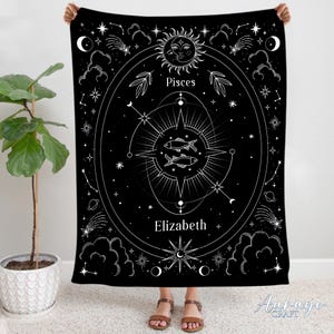 May include: Black tapestry with a white design featuring the Pisces zodiac sign, a compass, stars, and the name Elizabeth.