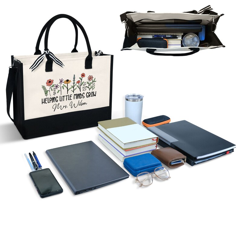 May include: A black and white tote bag with a floral design and the text "Helping Little Minds Grow Mrs. Wilson". The bag is open and filled with various items, including books, a laptop, a phone, a water bottle, and a pair of glasses.