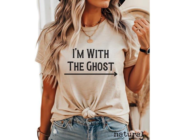 May include: A beige t-shirt with the text "I'm with the ghost" and an arrow pointing to the right.