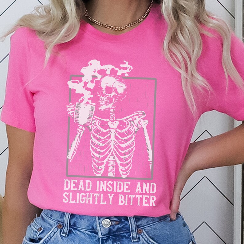May include: A pink t-shirt with a white skeleton holding a coffee cup and the text "Dead inside and slightly bitter".