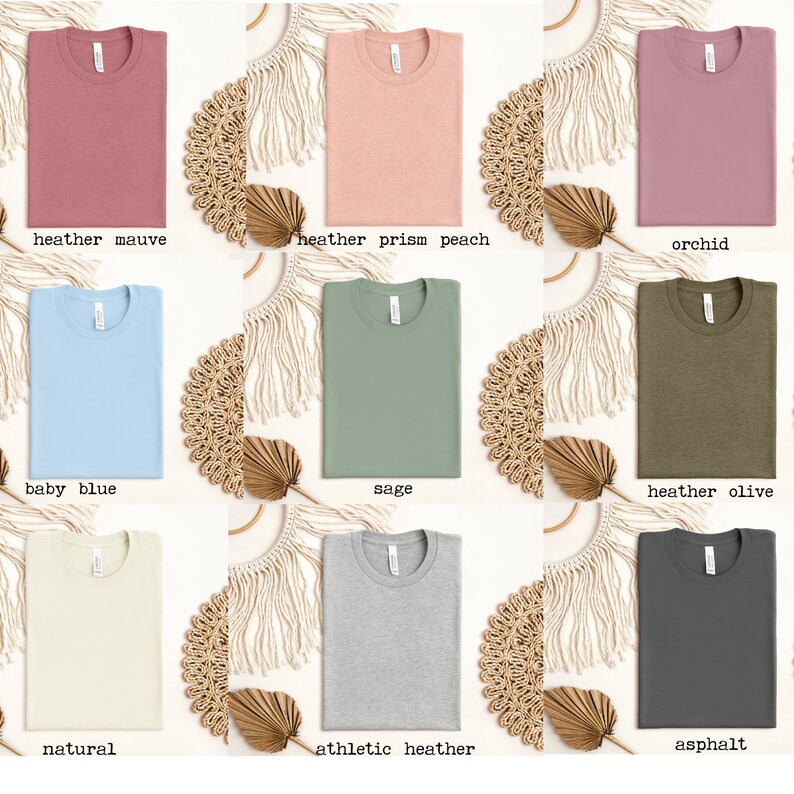 May include: A collection of ten blank t-shirts in various colors, including heather mauve, prism peach, orchid, baby blue, sage, heather olive, natural, athletic heather, and asphalt.