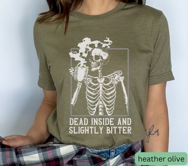 May include: A green t-shirt with a skeleton holding a cup of coffee and the text "Dead inside and slightly bitter".