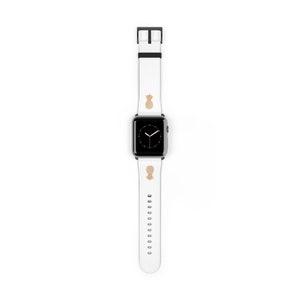 May include: White Apple Watch band with a gold pineapple design. The band is made of silicone and has a black buckle.