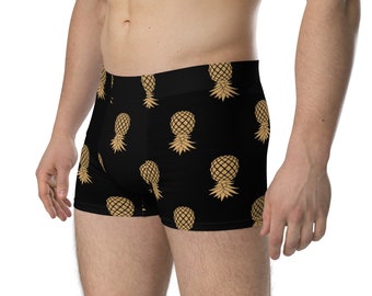 May include: Black boxer shorts with a gold pineapple pattern.