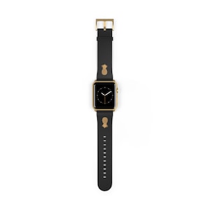 May include: A gold Apple Watch with a black leather band featuring a pineapple design. The watch face is black with white hands and numbers.