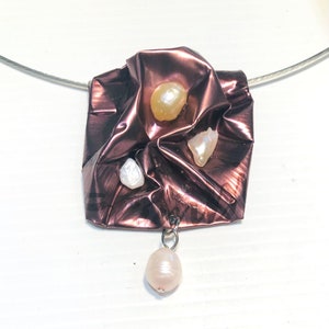 Pendant on stainless steel neckwire, recycled metals and reclaimed genuine pearls and stones.