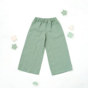 May include: A pair of light green linen pants with a wide leg and an elastic waistband.