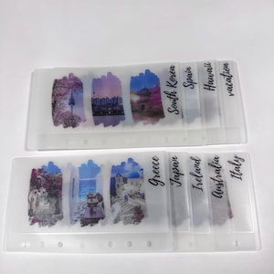 May include: A set of clear plastic dividers with colorful images and text labels for a planner or journal. The labels include: South Korea, Spain, Hawaii, vacation, Greece, Japan, Ireland, Australia, and Italy.